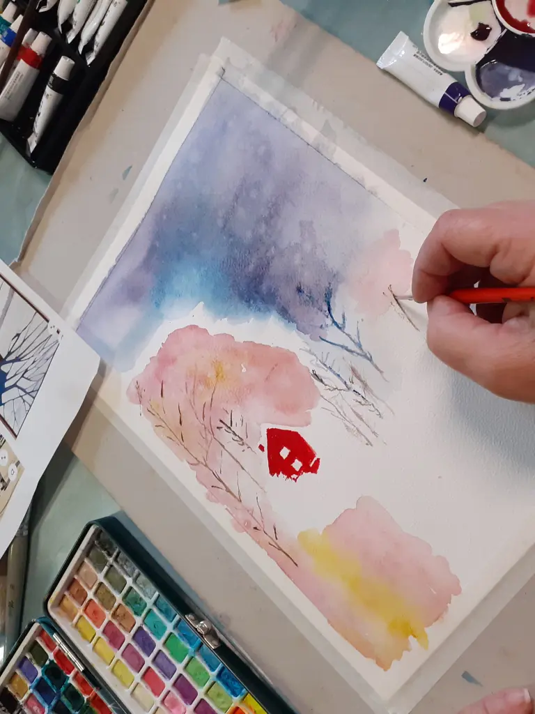 Personne entrain de peindre à l'aquarelle un paysage